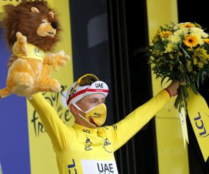 epa08681916 Slovenian rider Tadej Pogacar of the UAE-Team Emirates wearing the overall leader's yellow jersey celebrates on the podium after winning the 20th stage of the Tour de France cycling race, a 36.2km individual time trial from Lure to La Planche des Belles Filles, France, 19 September 2020.  EPA/Christophe Ena / Pool