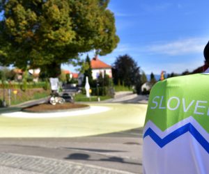 epa08683169 Locals gather at a roundabout painted in yellow and white in the village of Komenda, Slovenia, 20 September 2020, before last stage of 107th Tour de France. The village is the home town of cylcist Tadej Pogacar of the UAE-Team Emirates team who concquered the yellow jersey for overall leader before the Tour de France's last stage.  EPA/IGOR KUPLJENIK