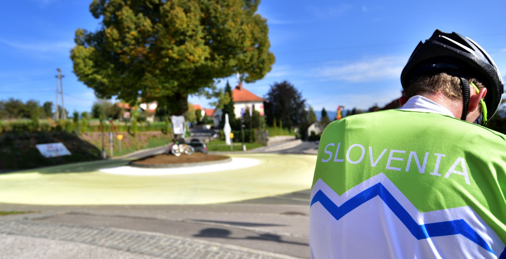epa08683169 Locals gather at a roundabout painted in yellow and white in the village of Komenda, Slovenia, 20 September 2020, before last stage of 107th Tour de France. The village is the home town of cylcist Tadej Pogacar of the UAE-Team Emirates team who concquered the yellow jersey for overall leader before the Tour de France's last stage.  EPA/IGOR KUPLJENIK