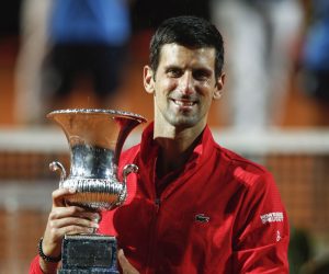 epa08686922 Novak Djokovic of Serbia celebrates with his trophy after the men's singles final round match at the Italian Open tennis tournament in Rome, Italy, 21 September 2020.  EPA/Clive Brunskill / POOL