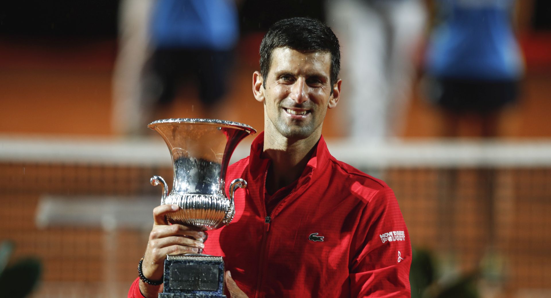 epa08686922 Novak Djokovic of Serbia celebrates with his trophy after the men's singles final round match at the Italian Open tennis tournament in Rome, Italy, 21 September 2020.  EPA/Clive Brunskill / POOL