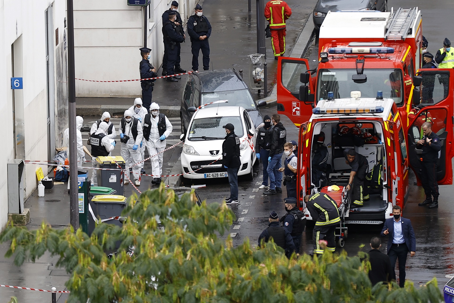 epa08696582 French police investigators work on the site of the knife attack near the former Charlie Hebdo offices, in Paris, France, 25 September 2020, after two people have been wounded. According to recent reports, two assailants have been arrested in the Bastille area.  EPA/IAN LANGSDON