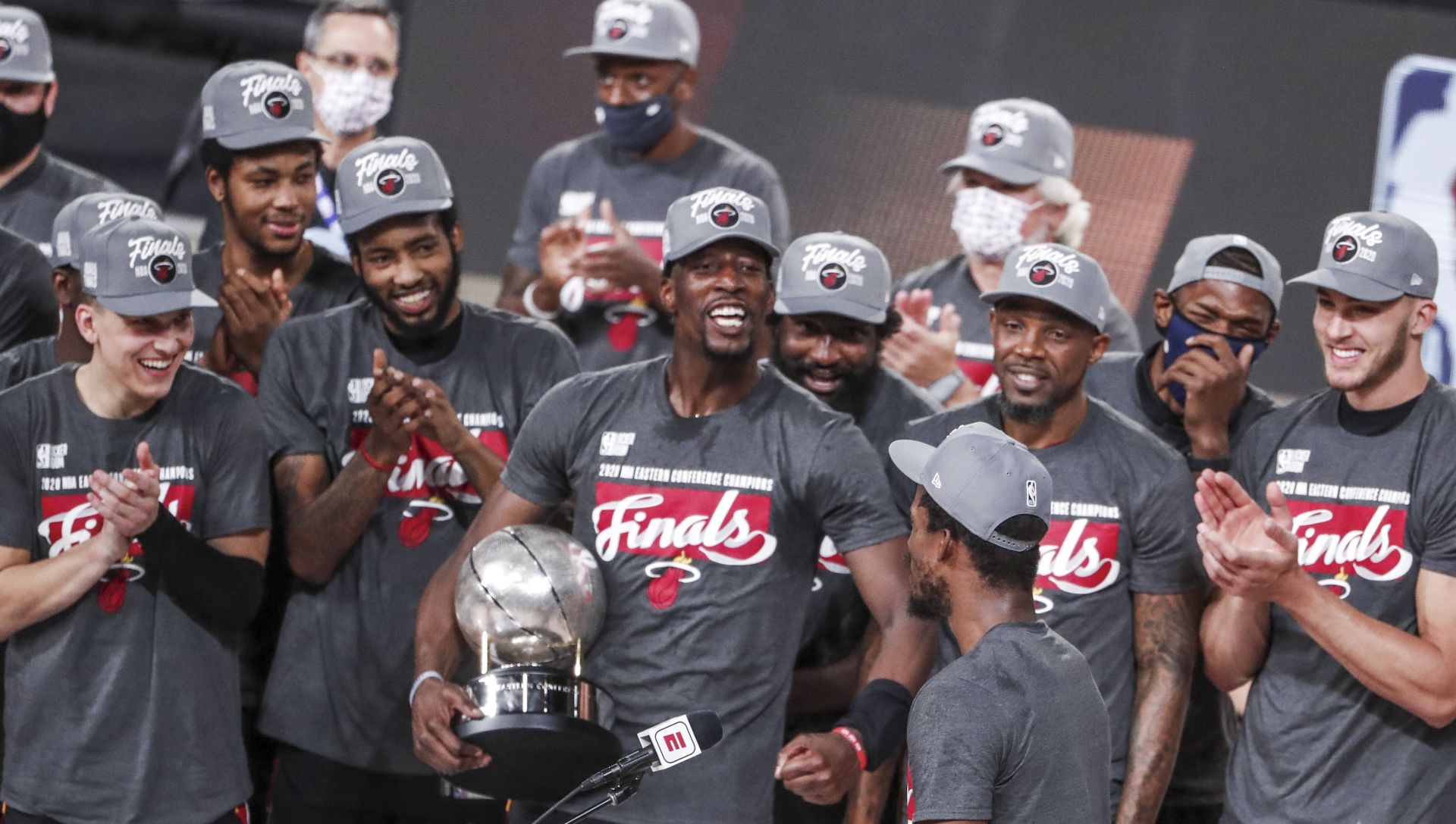 epa08702833 Miami Heat forward Bam Adebayo (C) holds the Eastern Conference Championship trophy as he celebrates with teammates after the NBA basketball Eastern Conference finals playoff game six between the Boston Celtics and the Miami Heat at the ESPN Wide World of Sports Complex in Kissimmee, Florida, USA, 27 September 2020. The Head won the game and will face the Los Angeles Lakers in the NBA Championship Finals.  EPA/ERIK S. LESSER SHUTTERSTOCK OUT