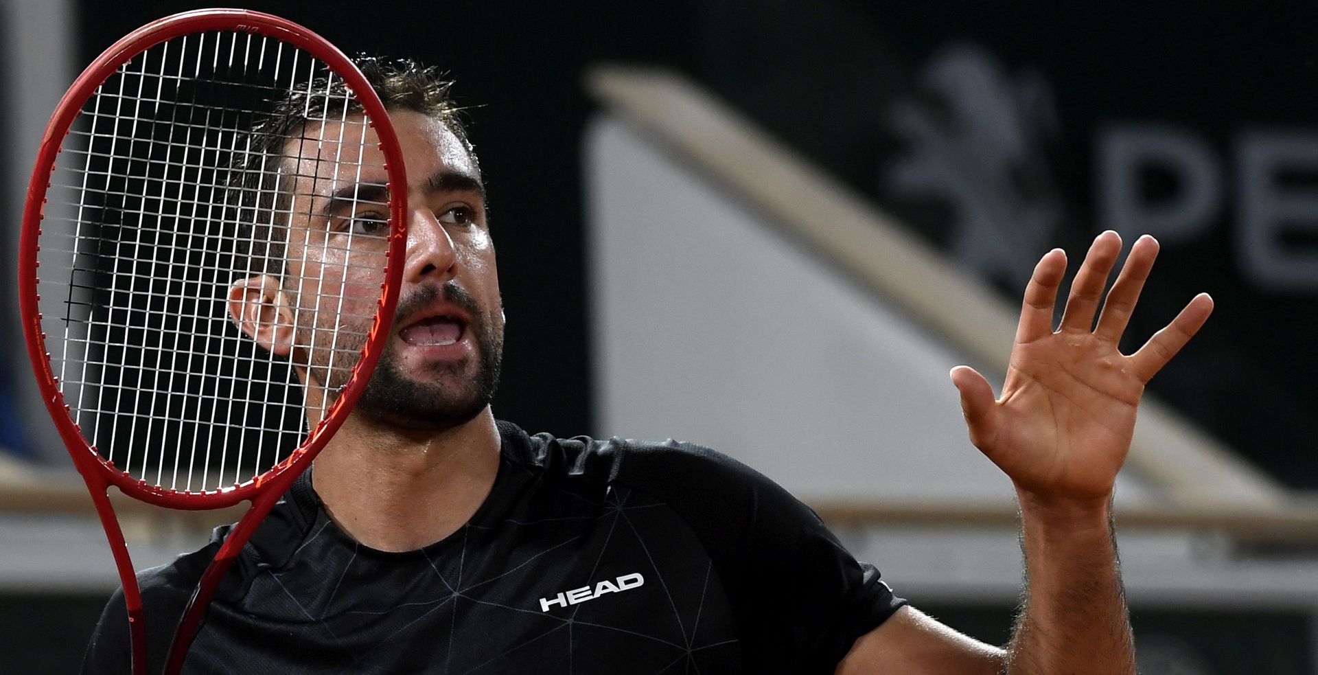 epa08703450 Marin Cilic of Croatia reacts as he plays  Dominic Thiem of Austria during their men’s first round match during the French Open tennis tournament at Roland ​Garros in Paris, France, 28 September 2020.  EPA/JULIEN DE ROSA
