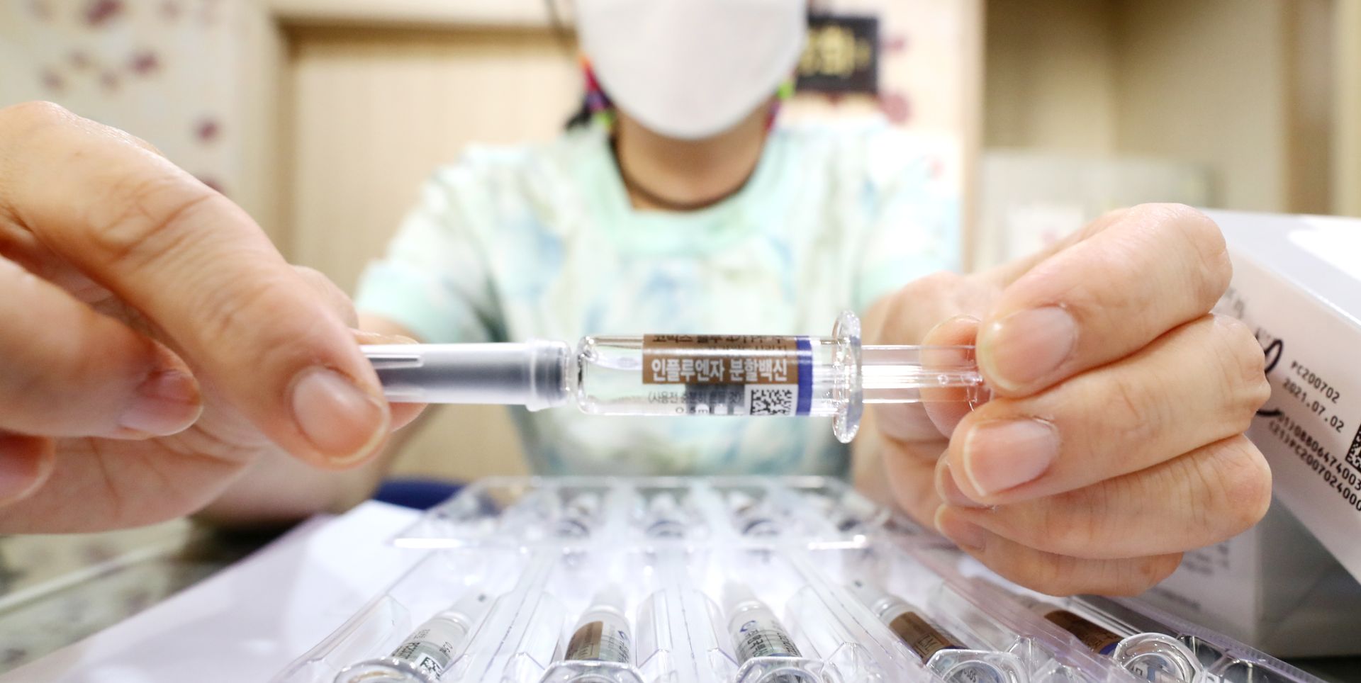 epaselect epa08687568 A nurse shows a flu vaccine at a clinic in Seoul, South Koream 22 September 2020. The Korea Disease Control and Prevention Agency said on 22 September, South Korea will temporarily halt its plan to offer free seasonal flu vaccines due to storage issues involving inactivated bottles.  EPA/YONHAP SOUTH KOREA OUT