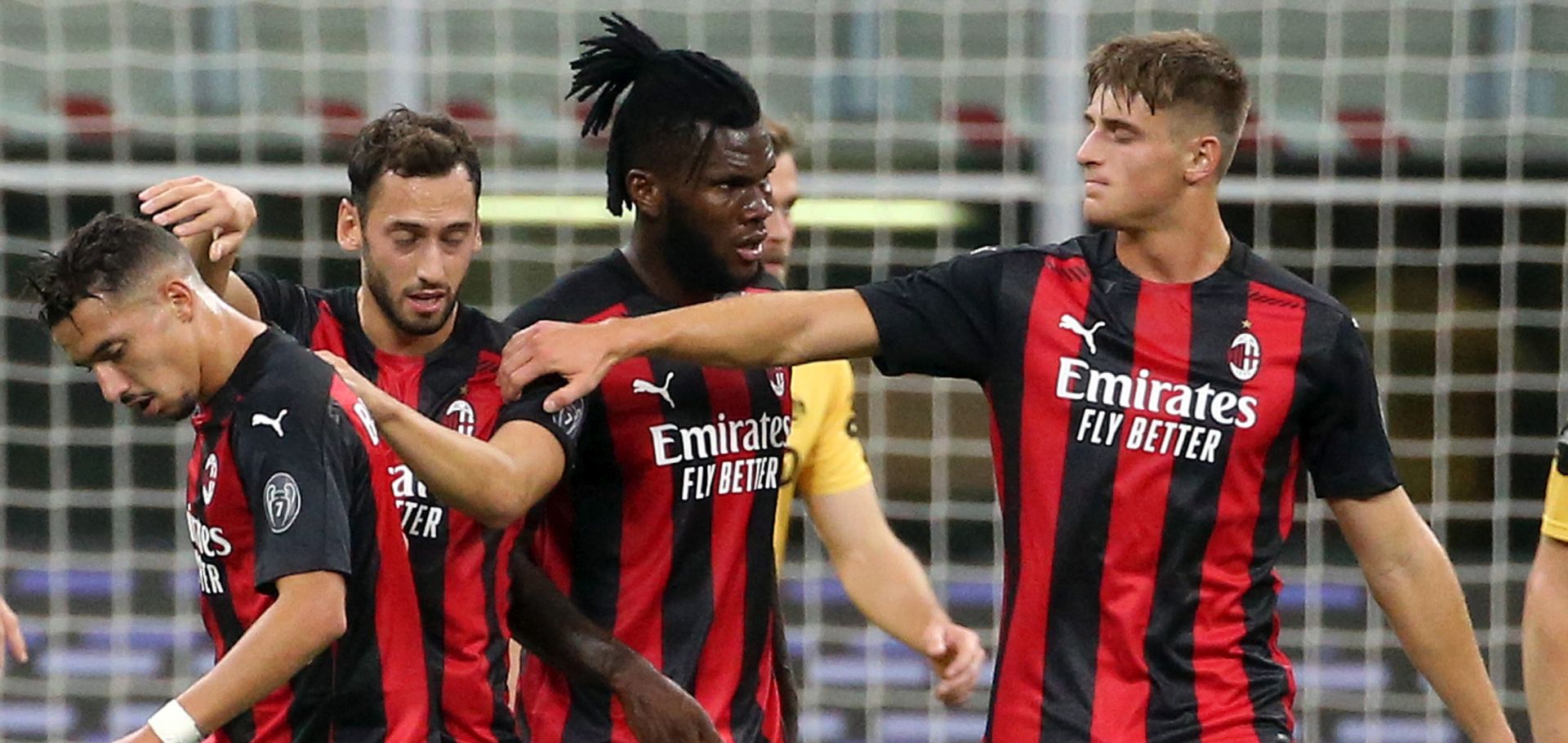 epa08694550 AC Milan's Hakan Calhanoglu (2L) celebrates with his teammates after scoring the 1-1 equalizer during the UEFA Europa League third qualifying round soccer match AC Milan vs Fk Bodo/Glimt at Giuseppe Meazza stadium in Milan, Italy, 24 September  2020.  EPA/MATTEO BAZZI
