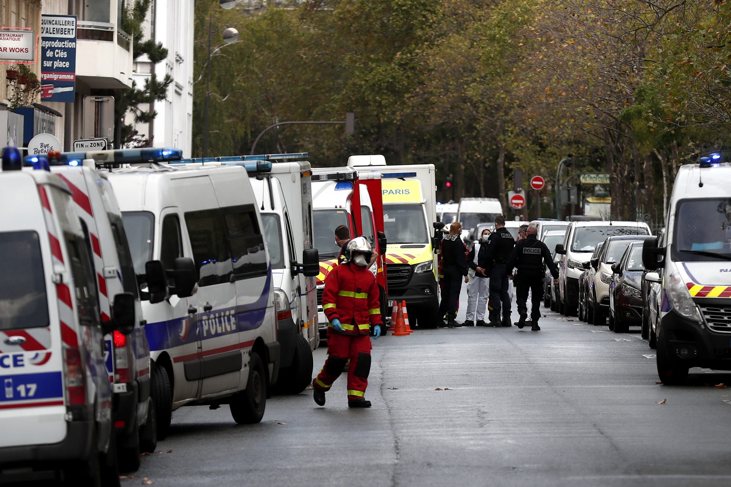 epa08696039 French police and rescue team stand at a security perimeter near the former Charlie Hebdo offices, in Paris, France, 25 September 2020, after four people have been wounded in knife attack. According to recent reports, two assailants are on the run.  EPA/IAN LANGSDON
