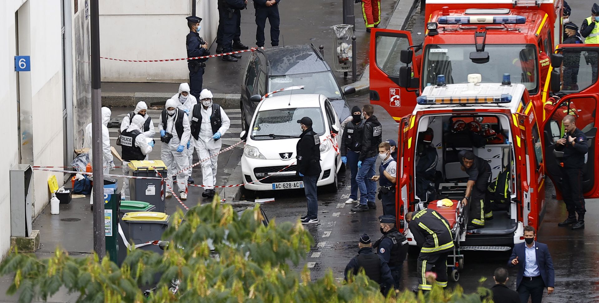 epa08696582 French police investigators work on the site of the knife attack near the former Charlie Hebdo offices, in Paris, France, 25 September 2020, after two people have been wounded. According to recent reports, two assailants have been arrested in the Bastille area.  EPA/IAN LANGSDON
