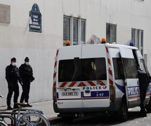 epa08698654 French police officers stand guard in front of the former Charlie Hebdo offices, on Rue Nicolas Appert in Paris, France, 26 September 2020, the day after a knife attack during which two people were wounded. A suspect was later apprehended nearby on Place de la Bastille, and has since revealed he intended to exact revenge for Charlie Hebdo's caricatures.  EPA/IAN LANGSDON