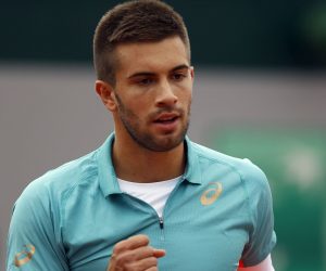 epa08701437 Borna Coric of Croatia in action against Norbert Gombos of Slovakia during their men’s first round match during the French Open tennis tournament at Roland Garros in Paris, France, 27 September 2020.  EPA/IAN LANGSDON