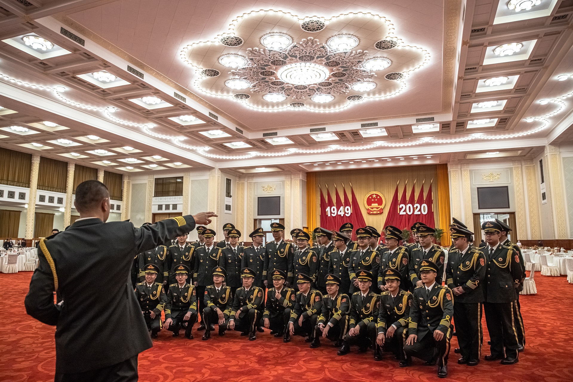 epa08708280 Chinese military orchestra gather for a group photos before performing during the National Day reception in a banquet hall at the Great Hall of the People (GHOP) in Beijing, China, 30 September 2020. China celebrates its National Day on 01 October, marking its 71st founding anniversary.  EPA/ROMAN PILIPEY
