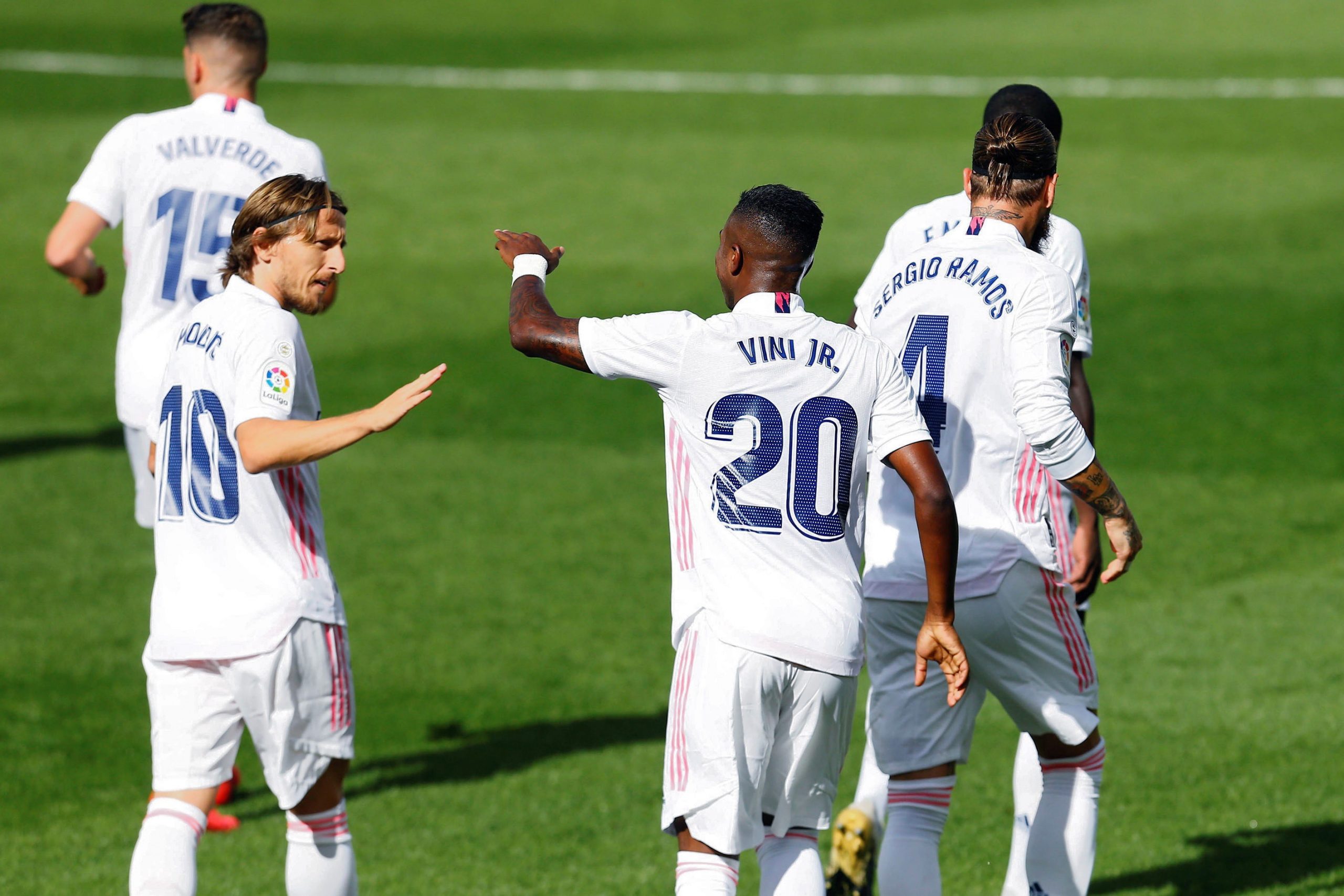 epa08720093 Real Madrid's Vinicius Jr. (C) celebrates with team mate Luka Modric (L)  after scoring the 1-0 lead during the Spanish LaLiga soccer match between UD Levante and Real Madrid at Ceramica stadium in Villarreal, eastern Spain, 04 October 2020.  EPA/DOMENENCH CASTELLO