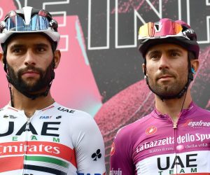 epa08724087 Italian rider Diego Ulissi (R) of UAE-Team Emirates in the points classification leader's cyclamen jersey and his Colombian team mate Fernando Gaviria attend the sign in ceremony before the 4th stage of the 2020 Giro d'Italia cycling race over 140 km from Catania to Villafranca Tirrena in Sicily, Italy, 06 October 2020.  EPA/LUCA ZENNARO