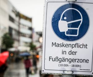 epa08761270 A sign reading âFace masks mandatory inside the pedestrian zoneÔ at the town centre of Delmenhorst, northern Germany, 21 October 2020. The provincial town with its 77,500 inhabitants has become a recent hotspot of the pandemic COVID-19 disease caused by the SARS-CoV-2 coronavirus as the incidence raised to over 200 cases on referential 100,000 inhabitants within the last seven days.  EPA/FOCKE STRANGMANN