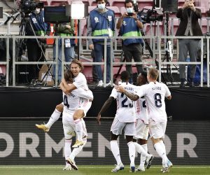 epa08771075 Real Madrid's Luka Modric (2-L) celebrates with teammates after scoring the 3-1 lead during the Spanish La Liga soccer match between FC Barcelona and Real Madrid, traditionally known as 'El Clasico', at Nou Camp in Barcelona, Spain, 24 October 2020.  EPA/Andreu Dalmau
