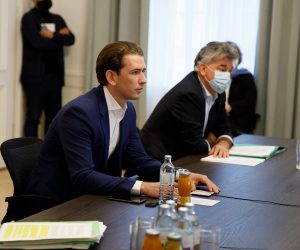 epa08788832 Austrian Chancellor Sebastian Kurz (L) speaks during a video conference next to Austrian Vice-Chancellor Werner Kogler (R) at the Austrian Chancellery in Vienna, Austria, 31 October 2020. Austrian government will introduce further strict measures to slow down the ongoing pandemic of the COVID-19 disease caused by the SARS-CoV-2 coronavirus.  EPA/FLORIAN WIESER