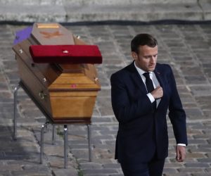 epa08762799 French President Emmanuel Macron leaves after paying his respects by the coffin of slain teacher Samuel Paty in the courtyard of the Sorbonne university during a national memorial event, in Paris, France, 21 October 2020. French history teacher Samuel Paty was beheaded in Conflans-Sainte-Honorine, northwest of Paris, by a 18-year-old Moscow-born Chechen refugee, who was later shot dead by police.  EPA/Francois Mori / POOL MAXPPP OUT