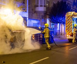 epa08792091 Firemen put out a fire as clashes erupted during a demonstration against coronavirus restrictions in Logrono, northern Spain, 01 November 2020.  EPA/RAQUEL MANZANARES