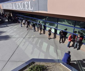 epa08795916 Voters line up prior to the opening of the polls at Shadow Ridge High School in Las Vegas, Nevada, USA, 03 November 2020. Americans vote on Election Day to choose between re-electing Donald J. Trump or electing Joe Biden as the 46th President of the United States to serve from 2021 through 2024.  EPA/DAVID BECKER