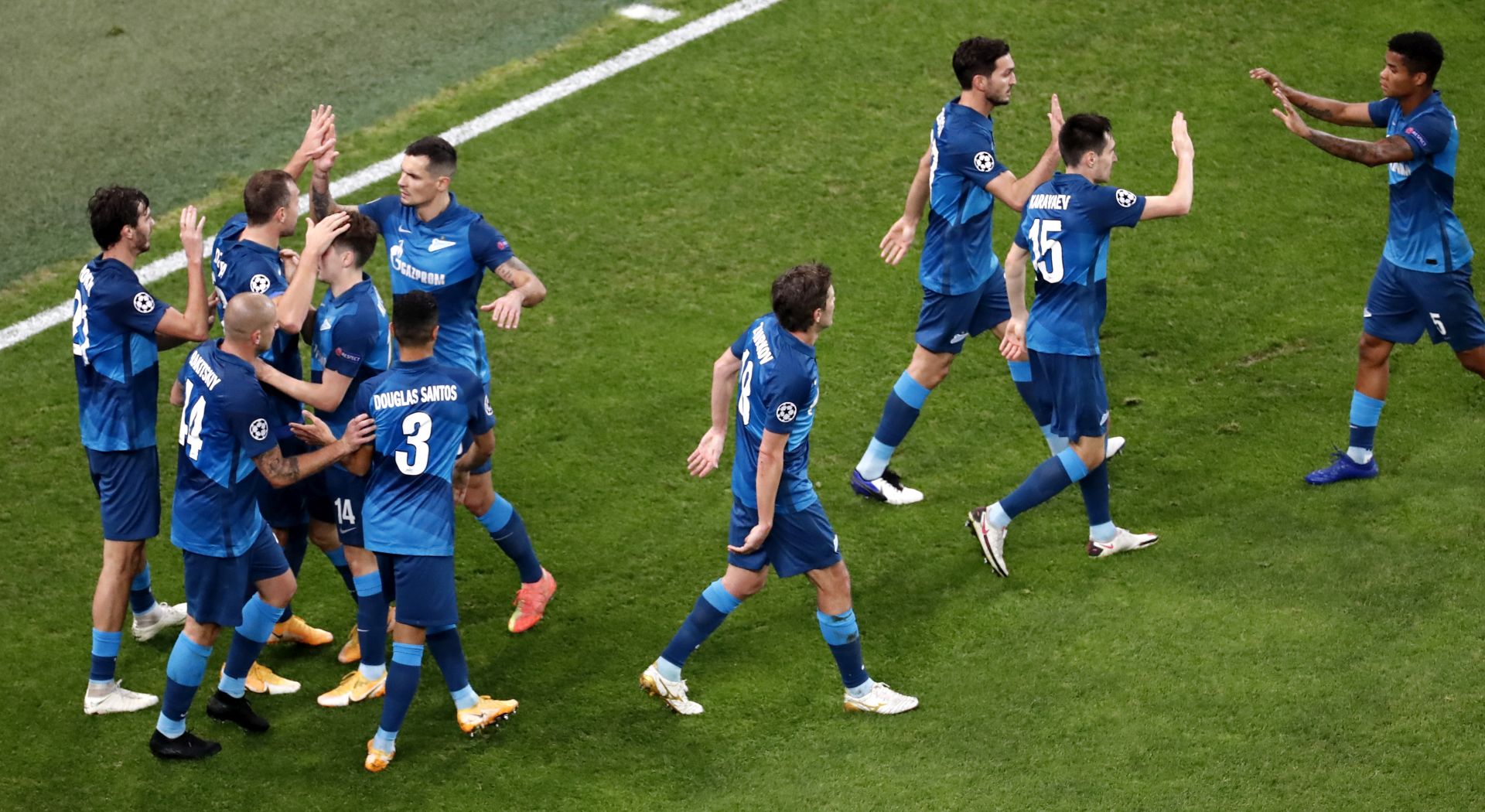 epa08798831 Aleksandr Erokhin (far left) of Zenit celebrates with teammates after scoring the opening goal during the UEFA Champions League group F soccer match between FC Zenit St. Petersburg and SS Lazio in St. Petersburg, Russia, 04 November 2020.  EPA/Anatoly Maltsev