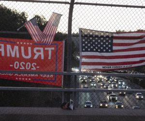epa08799584 Pro-US President Donald Trump flags hang from a fence at an overpass on a highway in Lafayette, California, USA, 04 November 2020. Americans voted on 03 November to choose the next president of the United States. The 2020 Presidential Election result remains undetermined as votes continued to be counted in several key battleground states.  EPA/JOHN G. MABANGLO