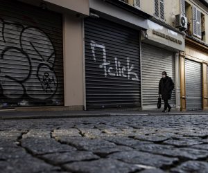 epa08799970 A pedestrian walks down a deserted street, as stores and souvenir shops remain shut due to lockdown measures, in Montmartre in Paris, France, 05 November 2020. France is placed in a second national lockdown, dubbed 'reconfinement' to battle a surge in Covid-19 coronavirus cases, averaging 40,000 new daily cases.  EPA/IAN LANGSDON