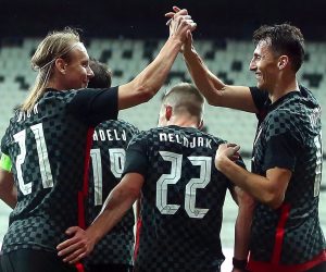 epa08815476 Ante Budimir (R) of Croatia celebrates with teammate Domagoj Vida (L) after scoring the 1-1 equalizer during the International Friendly soccer match between Turkey and Croatia in Istanbul, Turkey, 11 November 2020 (issued on 12 November 2020). Croatia's captain Domagoj Vida has been tested positive for the coronavirus COVID-19 disease early 12 November 2020 after playing the first half of the 3-3 draw with Turkey.  EPA/ERDEM SAHIN
