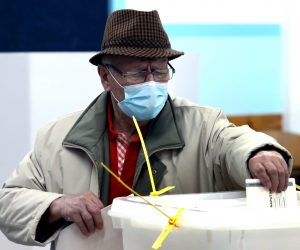 epa08821230 A voter wears a face mask as he casts his ballot for the local elections in Sarajevo, Bosnia and Herzegovina, 15 November 2020. More than three million Bosnian citizens are expected to vote in the country's Local elections.  EPA/FEHIM DEMIR