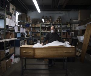 epa08823766 An employee works on a coffin in the coffin preparation workshop in Ris Orangis, near Paris, France, 16 November 2020. France is in the midst of a second wave of the COVID-19 coronavirus pandemic and faces an increase in the number of people affected by the virus.  EPA/Julien de Rosa