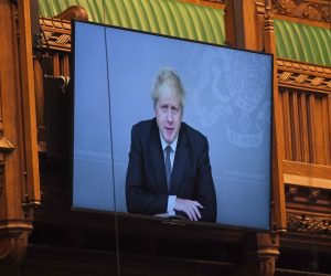 epa08827833 A handout photo made available by the UK Parliament shows Britain's Prime Minister Boris Johnson on a large screen as he takes part virtually in the Prime Minister's Questions (PMQs) in the House of Commons at Parliament in London, Britain, 18 November 2020. British Prime Minister Boris Johnson, who battled a coronavirus infection earlier this year, is self-isolating after having been exposed to the coronavirus again  EPA/JESSICA TAYLOR / UK PARLIAMENT / HANDOUT MANDATORY CREDIT: JESSICA TAYLOR / UK PARLIAMENT HANDOUT EDITORIAL USE ONLY/NO SALES