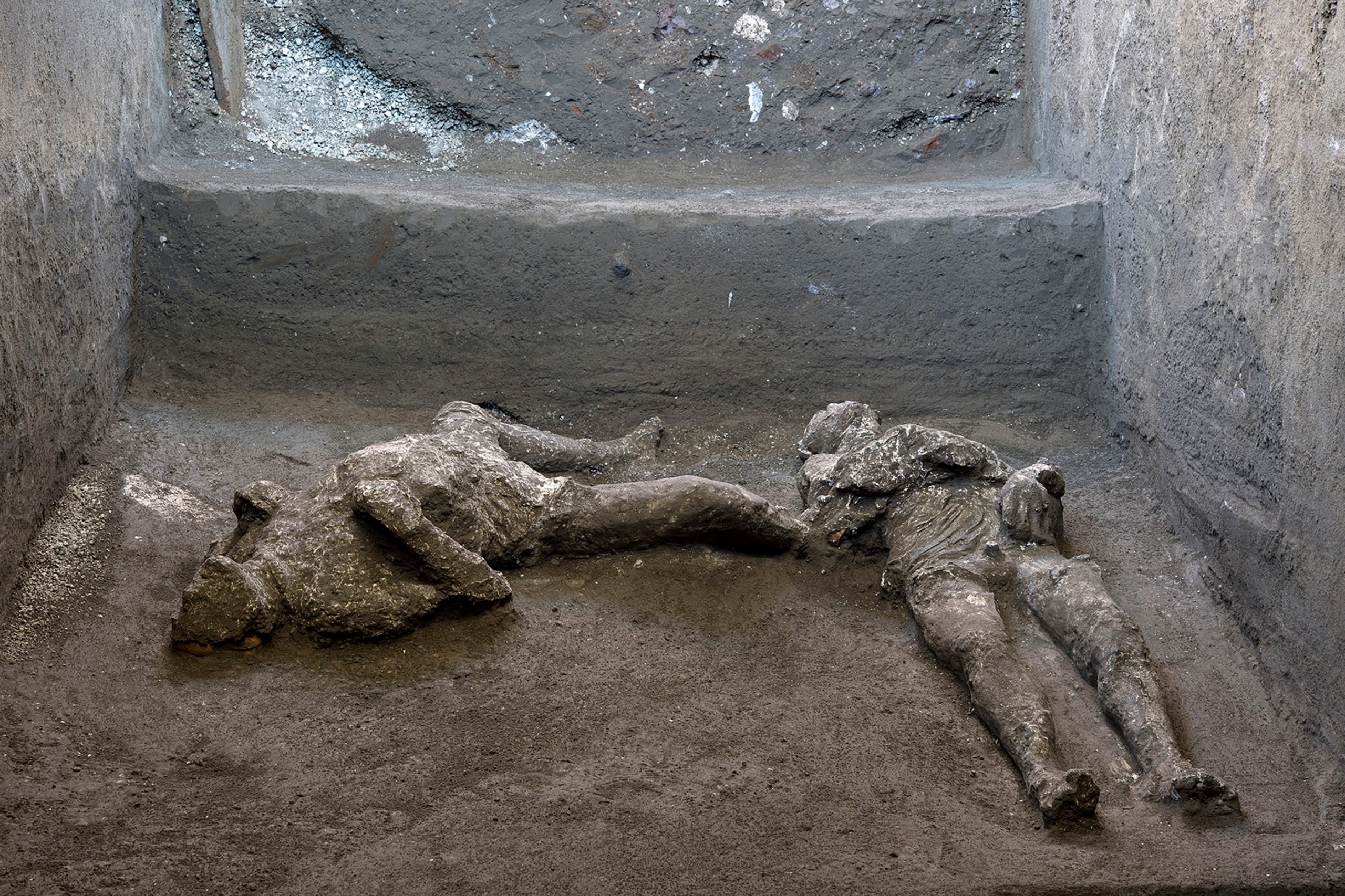 epa08832488 A handout photo made available by Parco Archeologico of Pompeii shows  two bodies, master and slave: they are the almost intact bodies of two men, a forty-year-old wrapped in a warm wool cloak and his young slave already bent by the fatigues of life, in Pompeii, Italy, 21 November 2020. "A truly exceptional discovery - underlines enthusiastic director Massimo Osanna, who has also headed the general management since September 2020 of public museums - because for the first time after more than 150 years from the first use of the technique it was possible not only to create perfectly successful casts of the victims, but also to investigate and document with new technologies the things they had with them in the moment in which they were hit and killed by the boiling vapors of the eruption ".  EPA/Luigi Spina /Parco Archeologico / HANDOUT  HANDOUT EDITORIAL USE ONLY/NO SALES