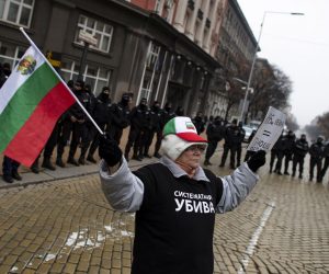epaselect epa08840576 A protester waves Bulgarian flag during a protest against coronavirus restrictions in Sofia, Bulgaria, 25 November 2020. Bulgarian Health Minister Kostadin Anguelov, announced on 25 November that starting from midnight of Friday 27th of November until 21st of December the authorities will impose almost full lockdown with closing all the schools, universities, kindergartens, as well as all non-essential shops like grocery shops retailers, pharmacies and drogeries.  EPA/VASSIL DONEV *** Local Caption *** A protester waves Bulgarian flag during a protest against the closure of the state of COVID-19 held in front of the Government building in Sofia, Bulgaria, 25 November 2020.