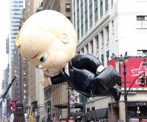 epa08844437 The 'BOSS BABY' balloon floats down 7th Avenue in front of the Macy's flagship store during the 94th Annual Macy's Thanksgiving Day Parade in New York, New York, USA, 26 November 2020. Due to the COVID-19 pandemic the Manhattan parade route will be reduced to just a few blocks of giant balloons, festive floats and performers. Some of the parade will be pre taped for the television broadcast.  EPA/JASON SZENES