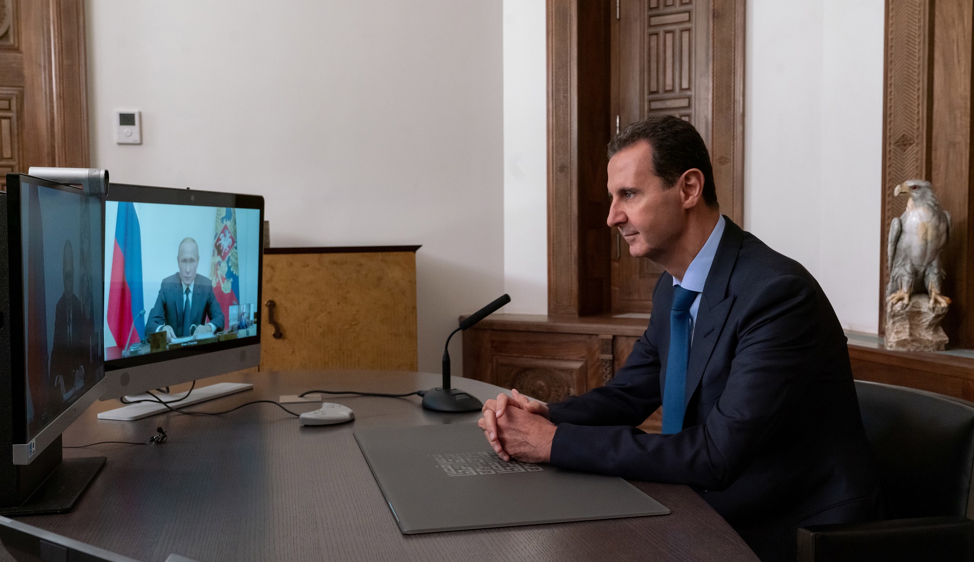 epa08809512 A handout photo made available by the Syrian Presidency shows Syrian President Bashar Assad during a video meeting with his Russian Counterpart Vladimir Putin, in Damascus, Syria, 09 November 2020.  on 9 November 2020. Assad said the upcoming Conference on Refugees Return scheduled to be held in Damascus will be the beginning of solving this humanitarian issue.  EPA/Syrian Presidency HANDOUT  HANDOUT EDITORIAL USE ONLY/NO SALES