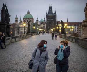 epa08810147 Women wearing protective face masks walk on Charles Bridge at dusk in Prague, Czech Republic, 09 November 2020. The Czech Republic has seen a declining trend in COVID-19 positive tested people after authorities imposed measures at the end of October to limit the increase in cases.  EPA/MARTIN DIVISEK