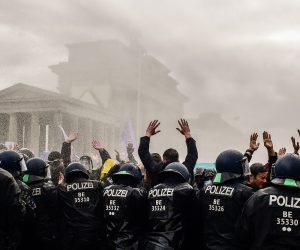 epa08827865 Riot police uses a water cannon to break up a demonstration against German coronavirus restrictions, near the Brandenburg Gate in Berlin, Germany, 18 November 2020. While German interior minister prohibited demonstrations around the Reichstag building during the parliamentary Bundestag session, people gathered to protest against government-imposed semi-lockdown measures aimed at curbing the spread of the coronavirus pandemic. Since 02 November, all restaurants, bars, cultural venues, fitness studious, cinemas and sports halls are forced to close for four weeks as a lockdown measure to rein in skyrocketing coronavirus infection rates.  EPA/FILIP SINGER