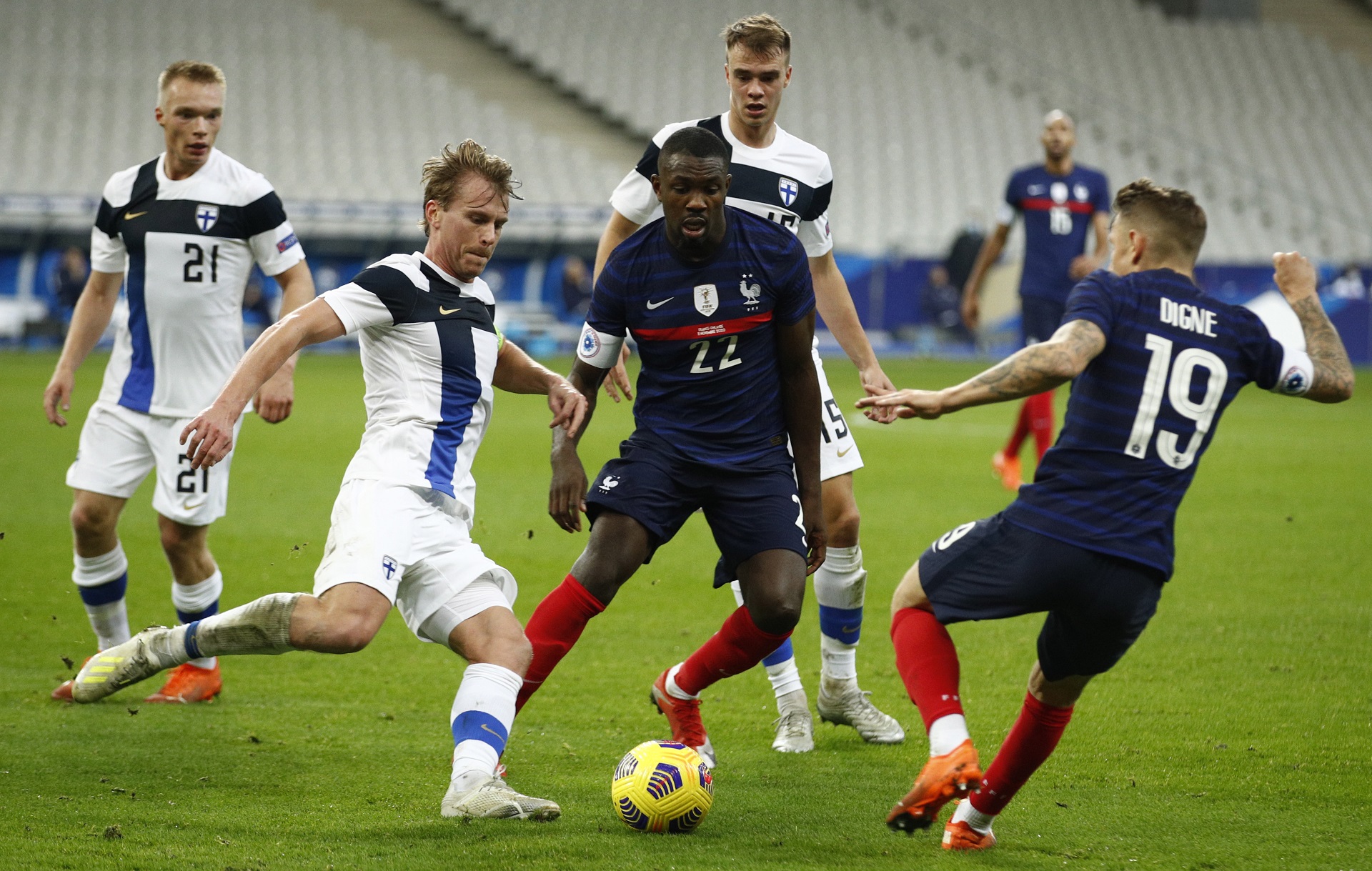 epa08814540 France's Lucas Digne (R), Marcus Thuram (C) and Finland's Rasmus Schueller  (L) in action during the friendly soccer match between France and Finland in Paris, France, 11 November 2020.  EPA/YOAN VALAT
