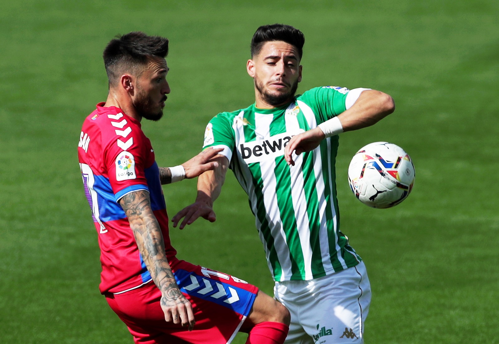 epa08791019 Real Betis' Alex Moreno (R) in action against Elche's Josan (L) during the Spanish La Liga soccer match between Real Betis and Elche CF at Benito Villamarin stadium in Seville, southern Spain, 01 November 2020.  EPA/Julio Munoz