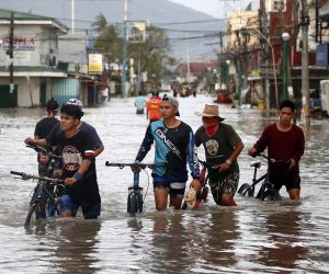 epa08790397 Filipino villagers wade along a flooded road in the typhoon-hit town of Nabua, Camarines Sur, Philippines, 01 November 2020. Super Typhoon Goni, with winds forecasted to reach over 240 kilometers per hour, made landfall on 01 November 2020, in the Philippine provinces of Albay, Camarines Sur and Quezon.  EPA/FRANCIS R. MALASIG