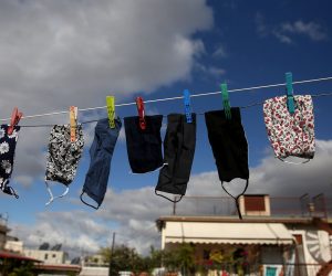 epa08807129 Face masks hang to dry from a rope between terraces in Athens, Greece, 08 November 2020. New restrictions have been enforced in Athens amid a second wave of COVID-19 infections sweeping through Europe.  EPA/ORESTIS PANAGIOTOU