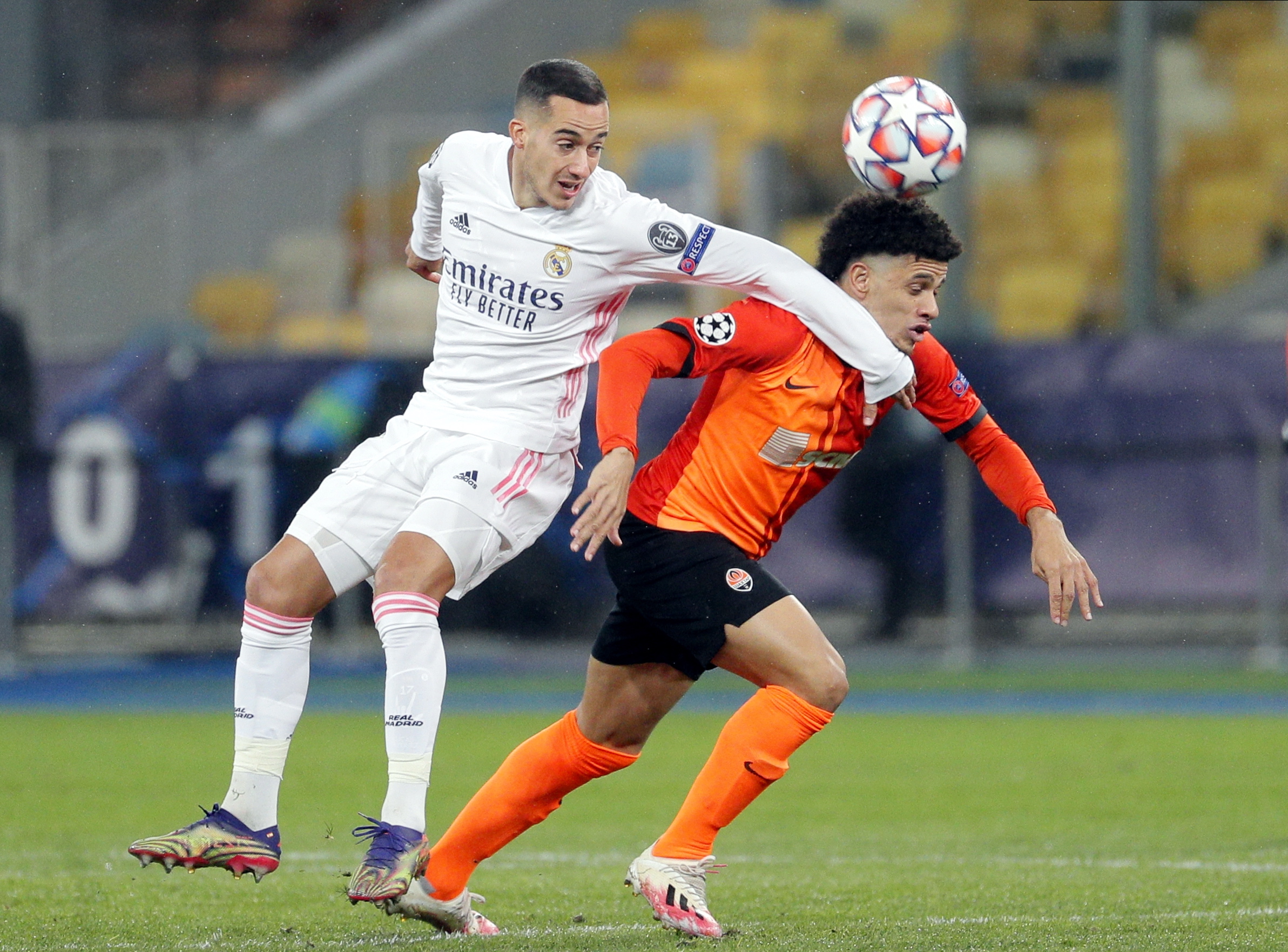 epa08855249 Taison (R) of Shakhtar in action against Lucas Vazquez (L) of Real Madrid during the UEFA Champions League group B match between Shakhtar Donetsk and Real Madrid in Kiev, Ukraine, 01 December 2020.  EPA/Sergey Dolzhenko