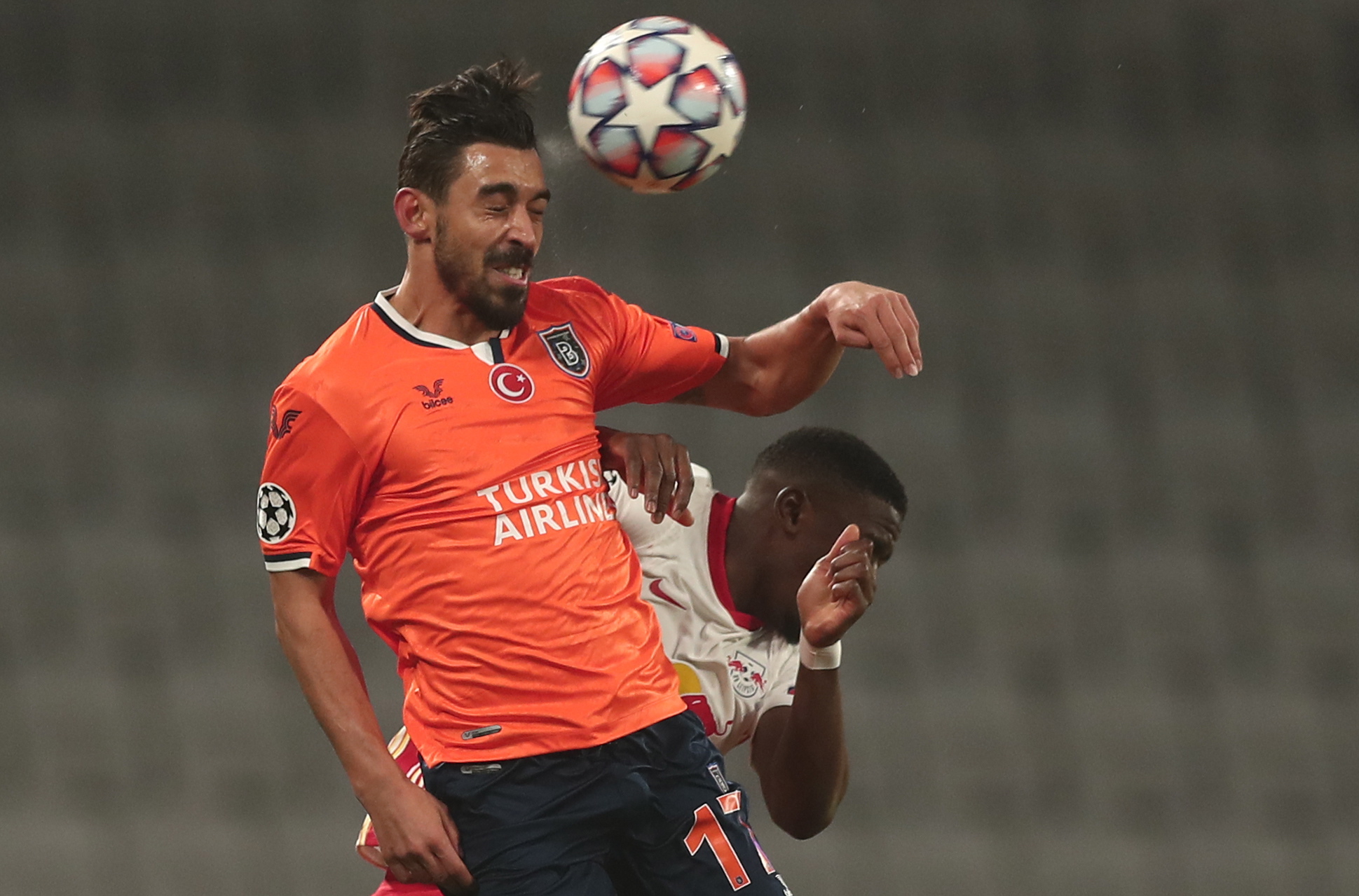 epa08857540 Irfan Can Kahveci (front) of Basaksehir in action against Nordi Mukiele (back) of Leipzig during the UEFA Champions League group H soccer match between Istanbul Basaksehir and RB Leipzig in Istanbul, Turkey, 02 December 2020.  EPA/SEDAT SUNA