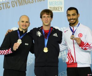 epa08882112 Gold medalist Matvei Petrov (C) of Albania, silver medalist Filip Ude (L) of Croatia and bronze medalist Ferhat Arican (R) of Turkey pose during the award ceremony of the men's pommel horse competition at the European Artistic Gymnastic Championships in Mersin, Turkey, 13 December 2020.  EPA/STR