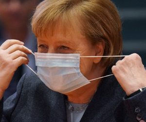 epa08886899 German Chancellor Angela Merkel wears a protective face mask as she arrives for the weekly government cabinet meeting during the second wave of the coronavirus pandemic in Berlin, Germany, 16 December 2020. Germany is launching a nationwide hard lockdown in an effort to rein in Covid-19 daily infection and death rates that have spiraled to record highs in recent days and weeks.  EPA/SEAN GALLUP / POOL