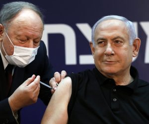 epa08894503 Israeli Prime Minister Minister Benjamin Netanyahu (R) receives a coronavirus disease (COVID-19) vaccine at Sheba Medical Center in Ramat Gan, Israel, 19 December 2020.  EPA/AMIR COHEN / POOL