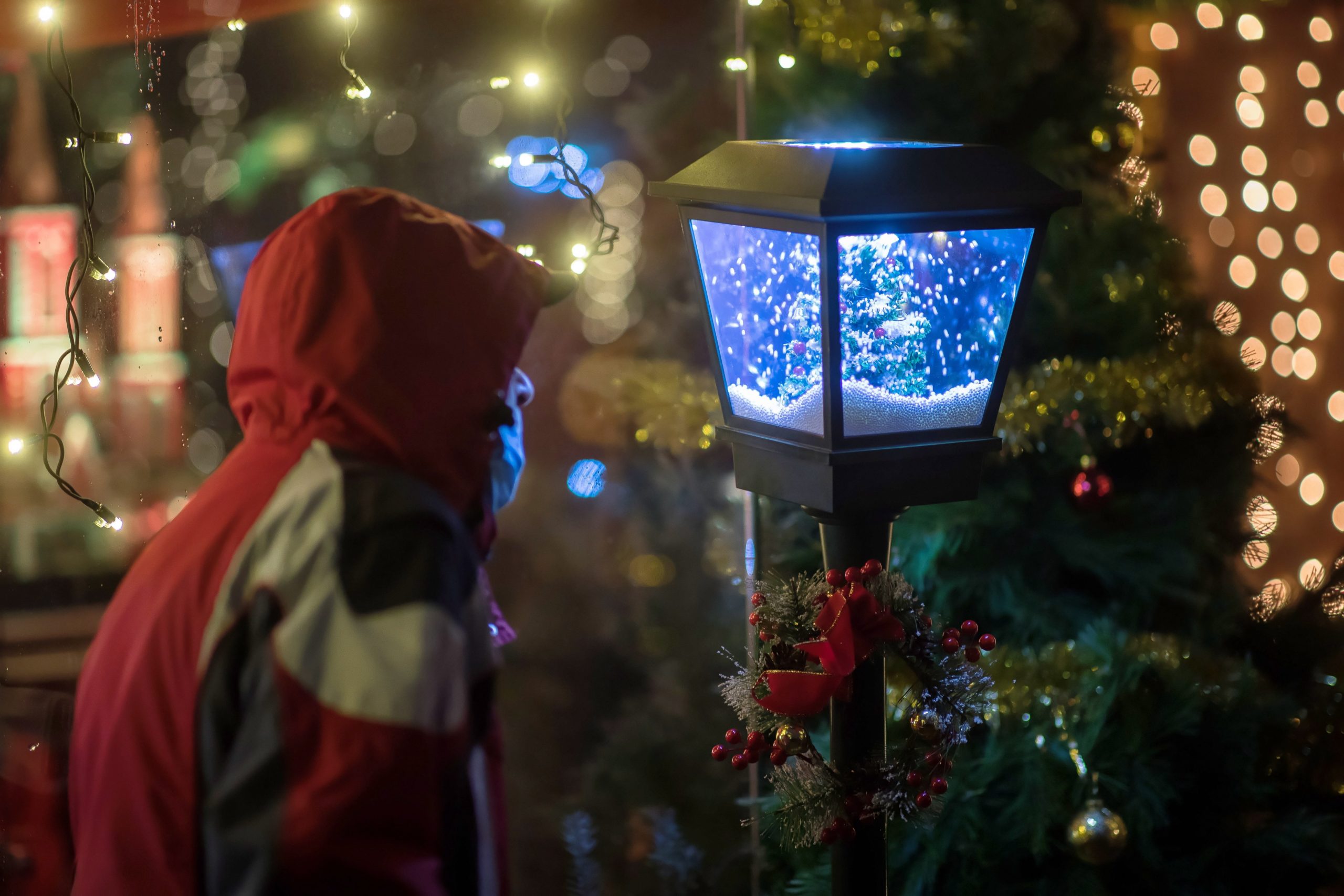 epa08896875 A visitor checks a decoration at a traditional Christmas market in front of the entrance to the Wieliczka Salt Mine, in Wieliczka, Poland, 20 December 2020.  EPA/LUKASZ GAGULSKI POLAND OUT