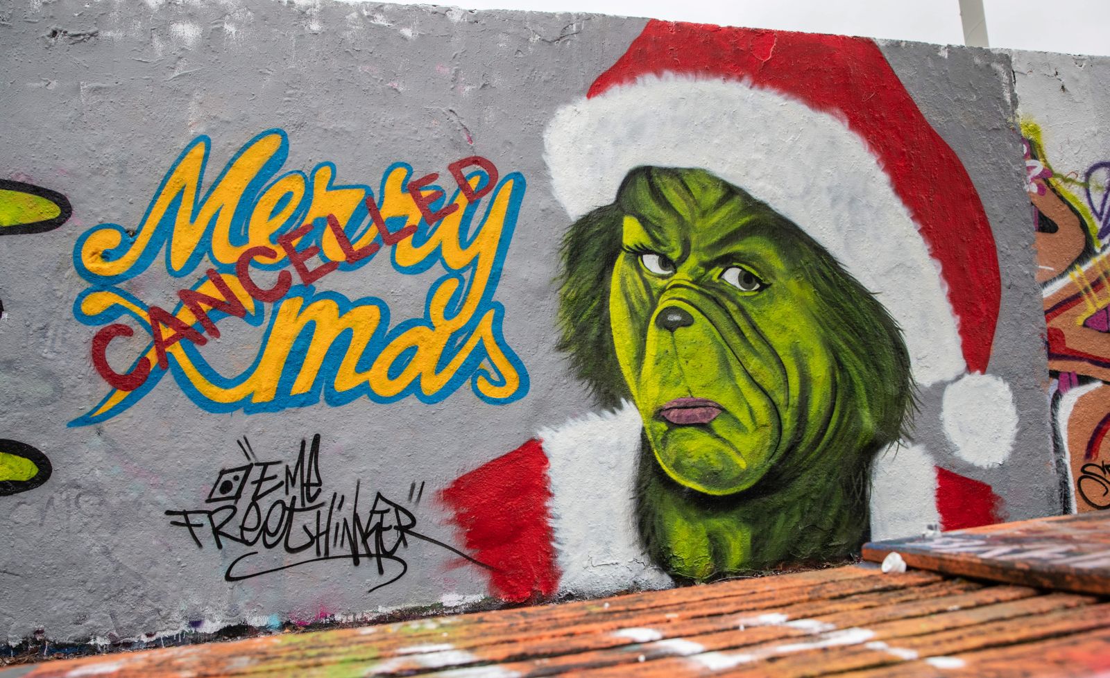 epa08899272 A mural reading 'Merry Xmas cancelled' is on display at the Mauerpark, a former part of the Berlin Wall, in Berlin, Germany, 22 December 2020. As the number of cases of the COVID-19 disease caused by the SARS-CoV-2 coronavirus is still rising throughout Germany, the government has imposed a second hard lockdown with businesses closing from 16 December on until 10 January 2021.  EPA/HAYOUNG JEON