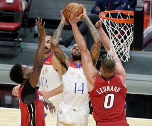 epa08903824 Miami Heat center Bam Adebayo (L), forward Meyers Leonard (R)  New Orleans Pelicans forward Brandon Ingram (C) in action during the first half of the NBA basketball game between the Miami Heat and the New Orleans Pelicans at AmericanAirlines Arena in Miami, Florida, USA, 25 December 2020.  EPA/RHONA WISE  SHUTTERSTOCK OUT