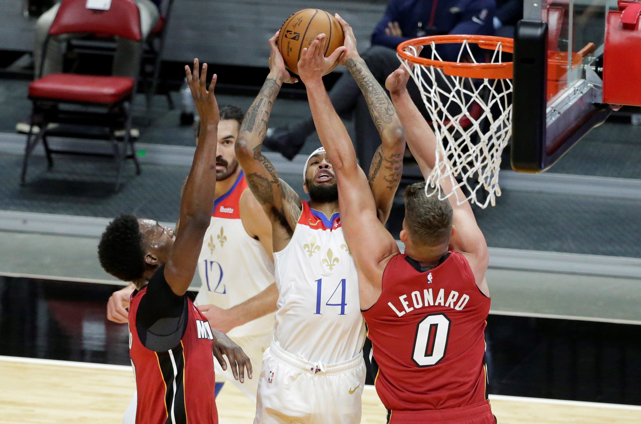 epa08903824 Miami Heat center Bam Adebayo (L), forward Meyers Leonard (R)  New Orleans Pelicans forward Brandon Ingram (C) in action during the first half of the NBA basketball game between the Miami Heat and the New Orleans Pelicans at AmericanAirlines Arena in Miami, Florida, USA, 25 December 2020.  EPA/RHONA WISE  SHUTTERSTOCK OUT
