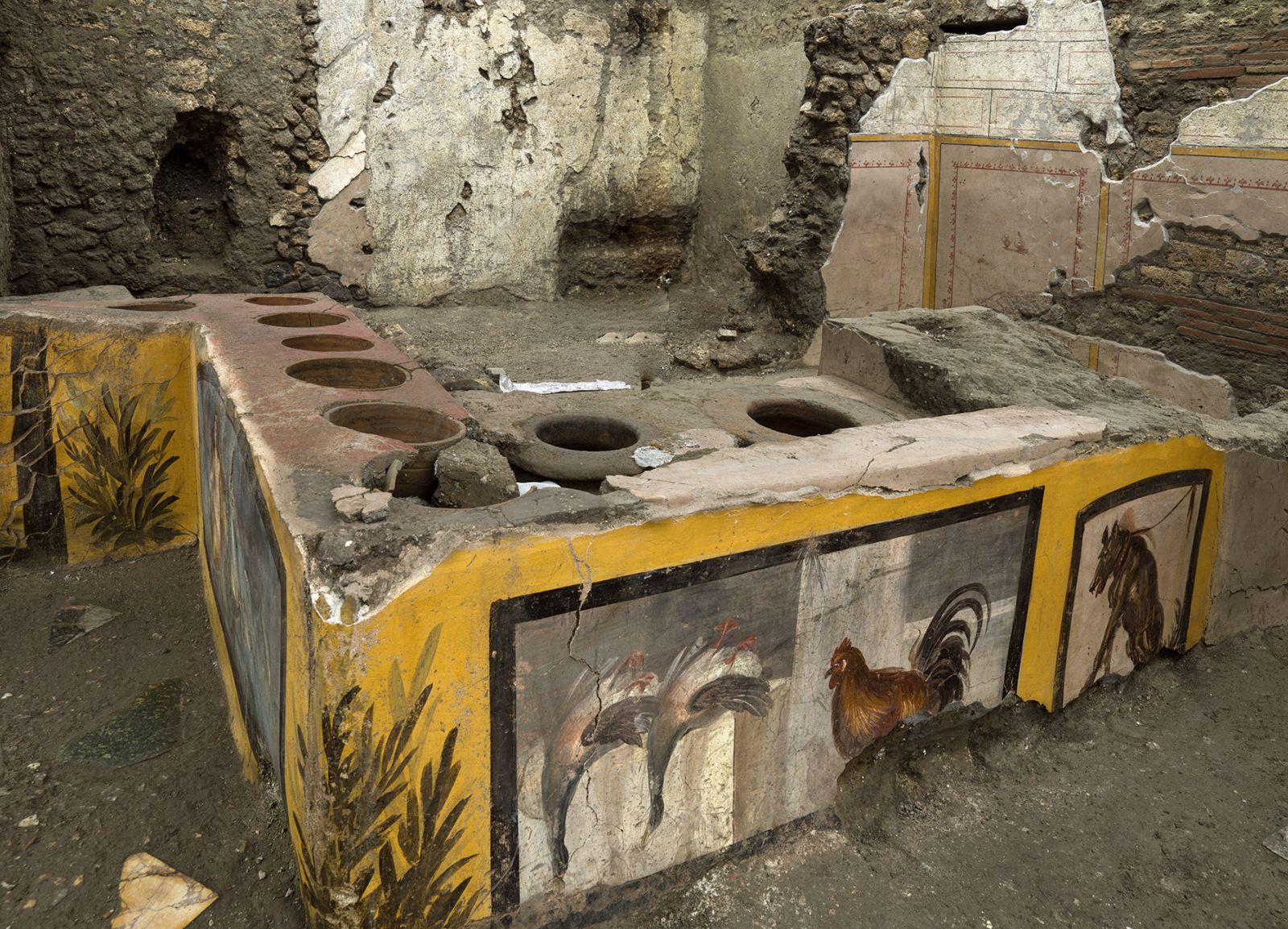 epa08904472 An undated handout photo made available by the Archaeological Park of Pompeii on 26 December 2020 shows a newly unearthed 'Thermopolium' at the archaeological site in Pompeii, Italy. The Thermopolium, a well-preserved frescoed 'fast food' counter in the park's Regio V area, will open to visitors at Easter 2021. The shop is located right in front of the 'Gladiator inn,' almost on the corner between the Vicolo dei Balconi and the Via della Casa delle Nozze d'Argento.  EPA/PARCO ARCHEOLOGICO DI POMPEI / HANDOUT  HANDOUT EDITORIAL USE ONLY/NO SALES